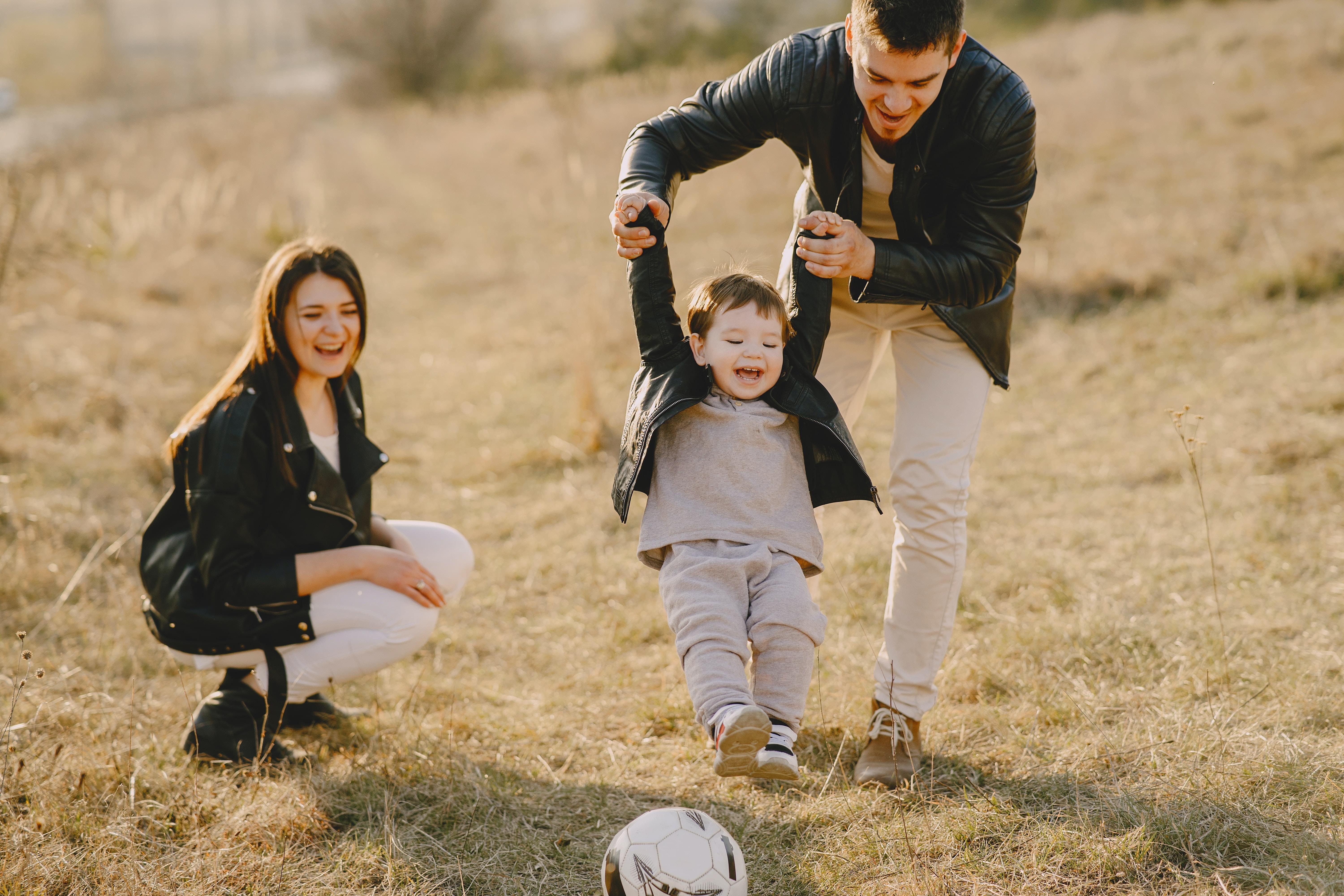 Family enjoying playing football